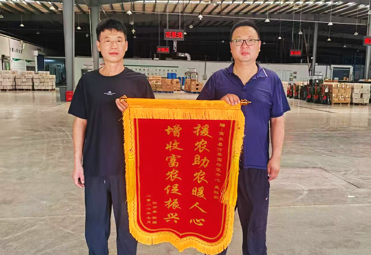 7月22日，农户代表来到商水县万果园物流中心，将印有“援农助农暖人心，增收富农促振兴”的锦旗.jpg
